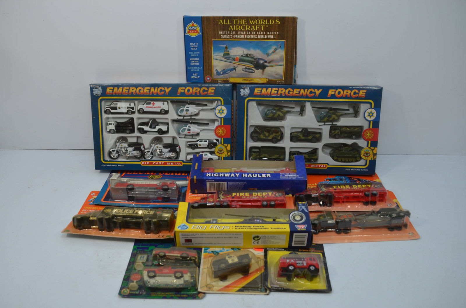 30 Assorted Die Cast Police, Fire, Rescue, and Army Vehicles: This is a lot of 30 die cast police, fire, rescue, and Army vehicles. Road Tough, AHM, Pro Engine,Motor Max, Maisto, and other manufacturers represented. All are new in their original packaging.
