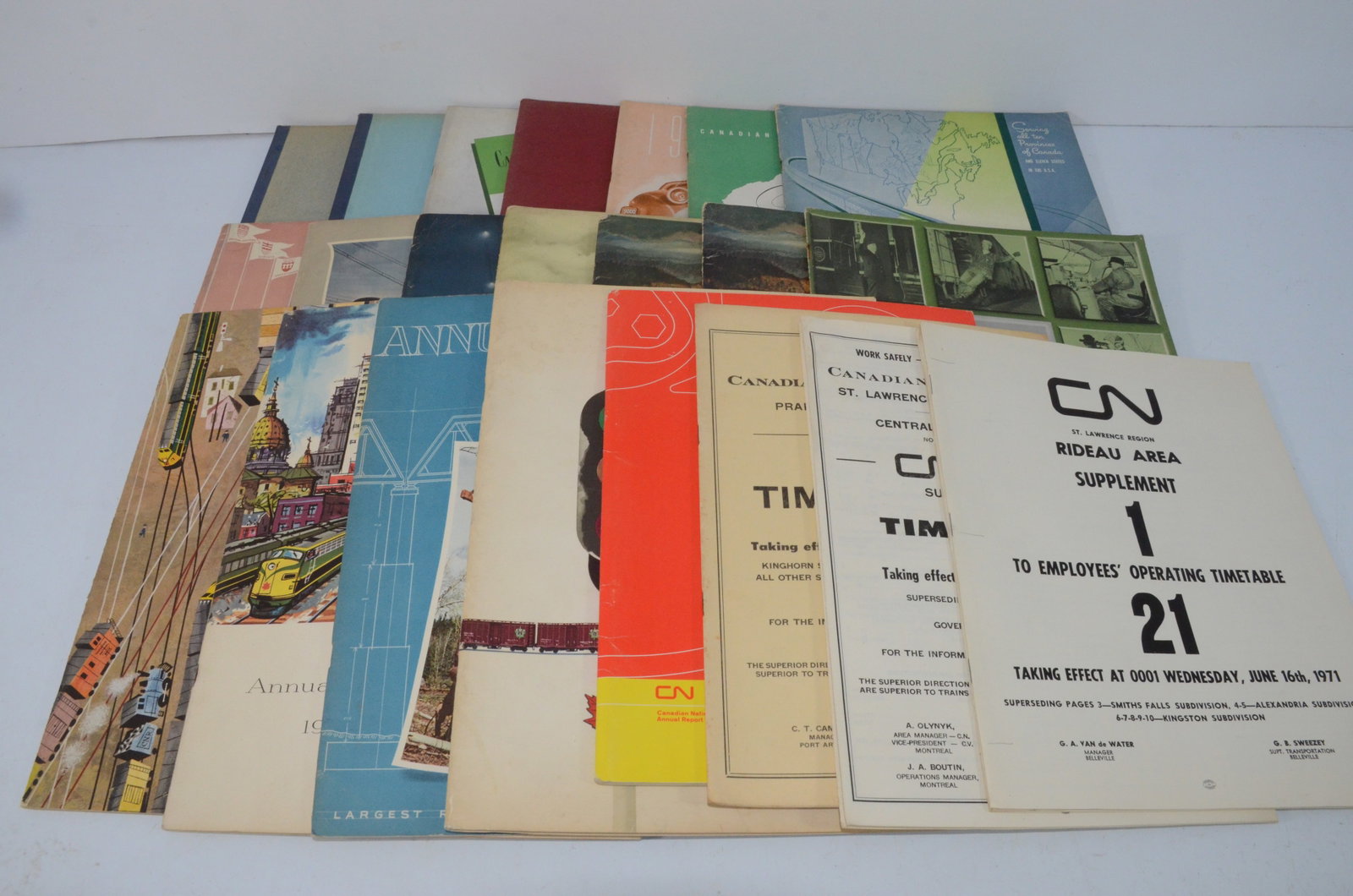 Canadian National RR Annual Report and Employee Timetable Lot 1930-1971: This is a lot of Canadian National Railroad annual reports and employee timetables. The annual reports include 1930, 1931, a complete run from 1945 through 1959, and 1969. The employee timetables incl