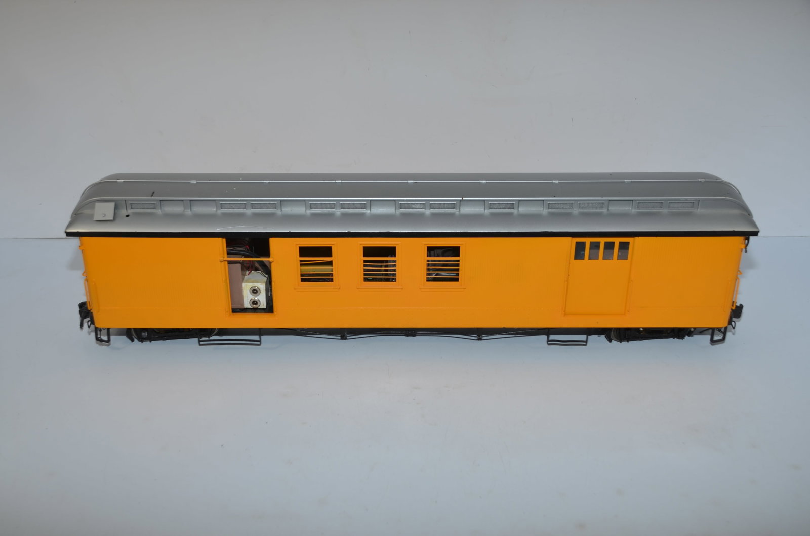 G Gauge Brass Passenger Car with Sierra Sound System: This is a G gauge brass passenger car. Heavy item! Painted, but unlettered. All four doors on the car slide open. There is one truck that is missing a journal box as can be seen in one of the photos. 