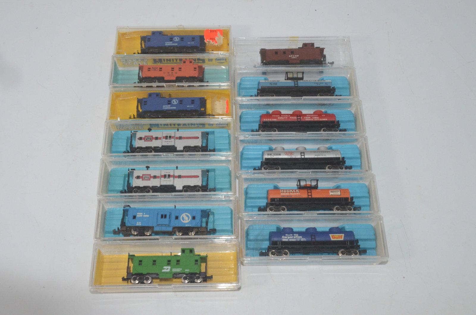 13 N Scale Cabooses and Tank Cars-New in Box: This is a lot of 13 N scale cabooses and tank cars that are new in their original boxes. Manufacturers include Atlas and AHM. Roads include GN, CBQ, BN, ATSF, UTLX, Union Starch, DuPont, Hooker, and G