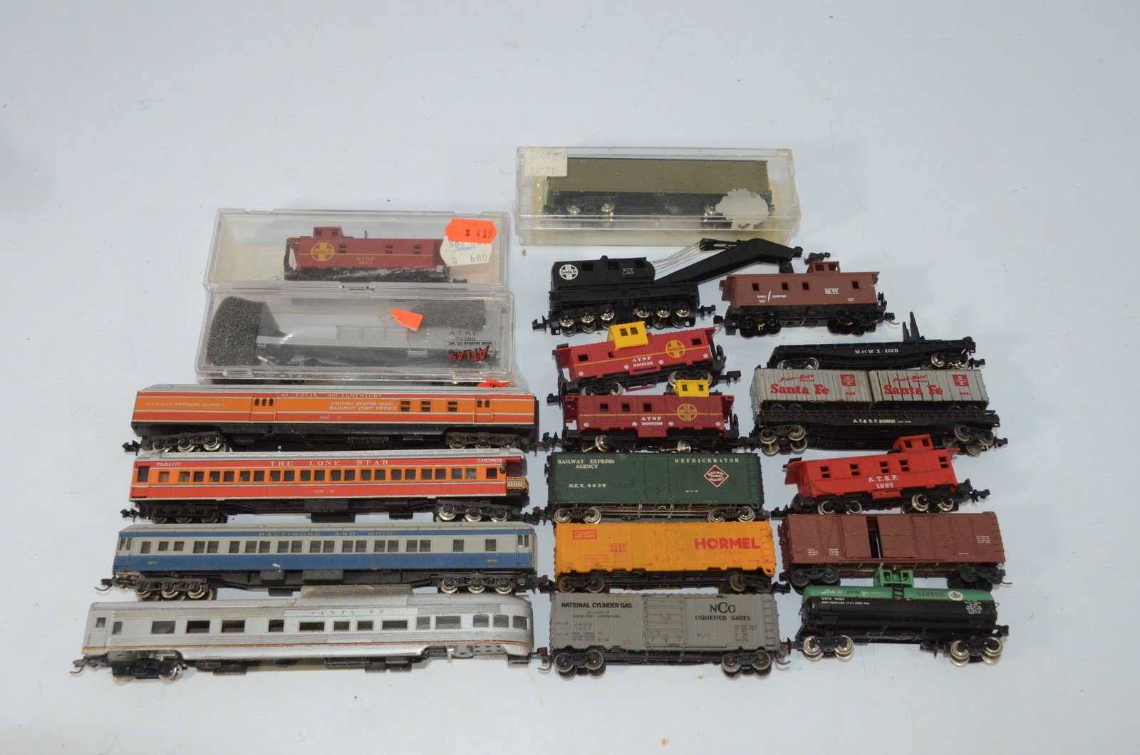 19 Mixed Used N Scale Freight and Passenger Cars: This is a lot of 19 mixed N scale freight and passenger cars. Coaches, cabooses, boxcars, refrigerator cars, tank cars, flat cars, piggyback flats, and even a wreck crane are included.