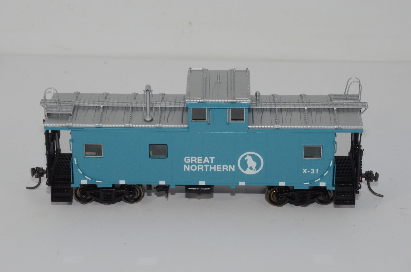Great Northern RR International Standard Cupola Caboose-Overland Brass-HO Scale: This is a Great Northern Railroad brass International standard cupola caboose #X-31 in HO scale. Made by Ajin Precision in Korea and distributed by Overland Brass Models. New in the original box.