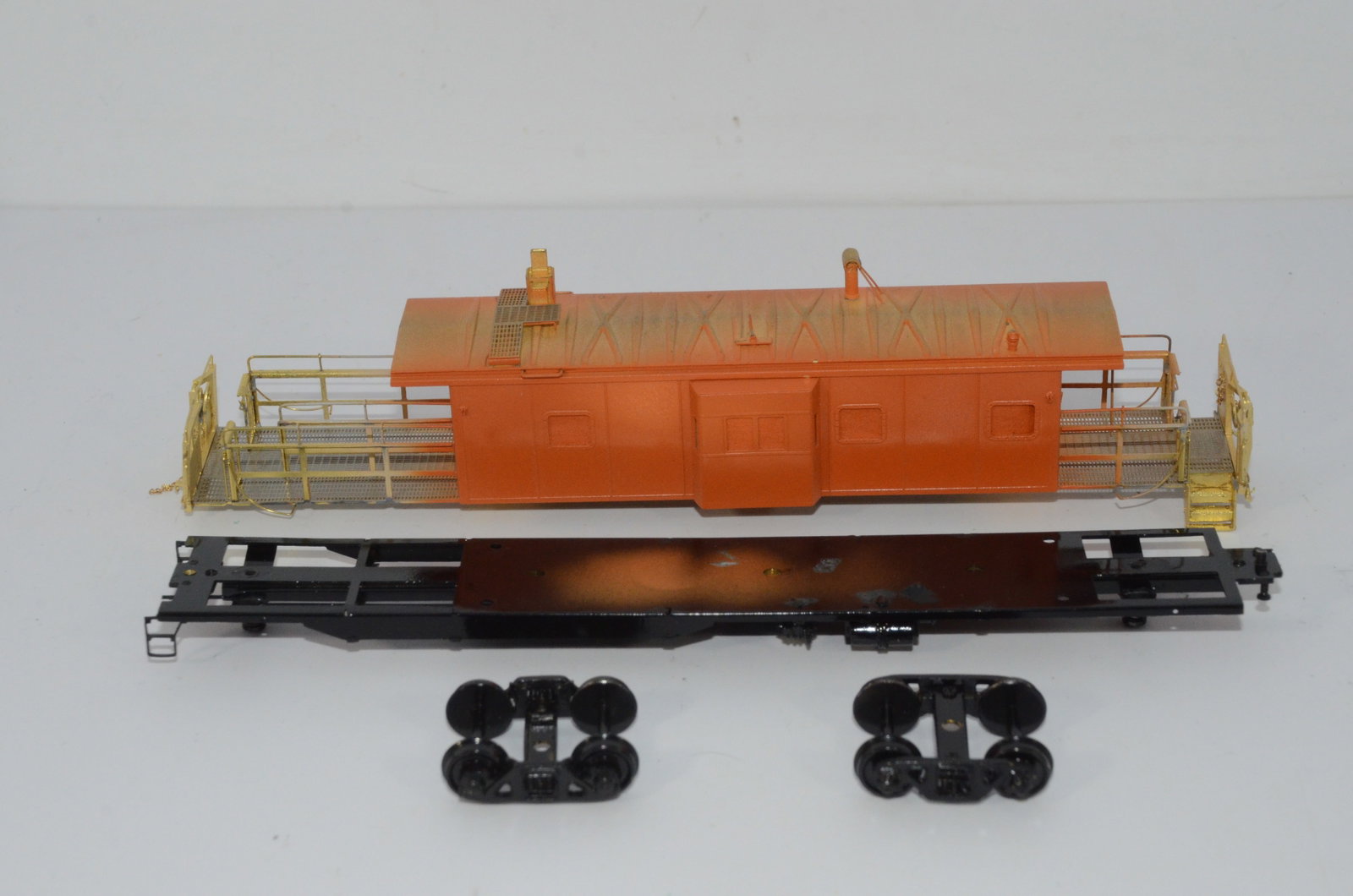 Milwaukee Road RR B-W Long Caboose-Overland Brass Models-HO Scale: This is a Milwaukee Road Railroad B-W long caboose in HO scale. Painted in Milwaukee Road orange, this model just needs final painting, assembly, and decalling to make a complete, beautiful, and very 