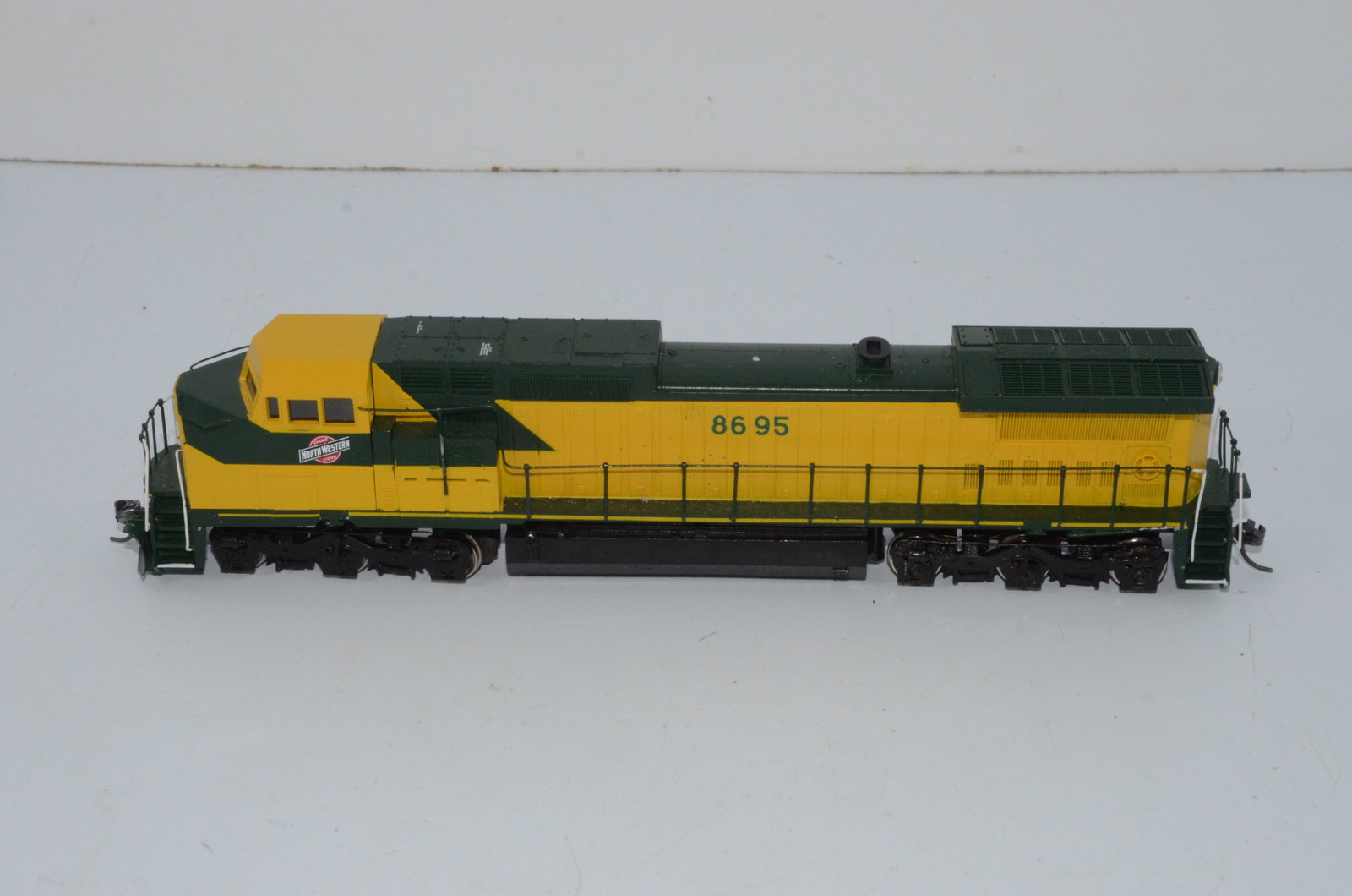 Chicago and Northwestern RR C44-9W Diesel Locomotive #8695-HO Scale: This is a Chicago and Northwestern Railroad C44-9W diesel locomotive #8614 in HO scale. Custom painted and decalled plastic shell by Lochmann Trains, it comes with an Ajin Precision drive from Korea. 
