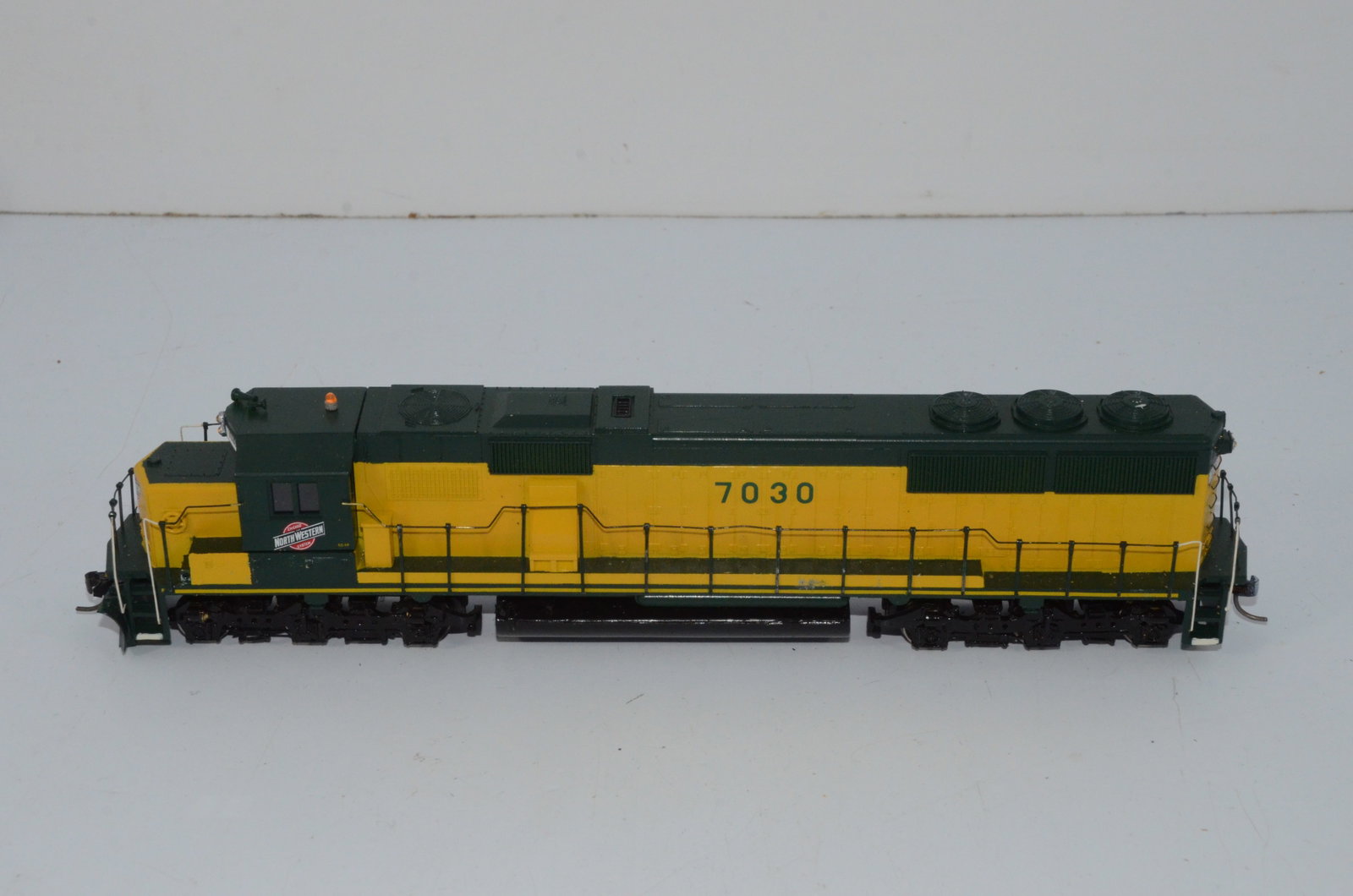 Chicago and Northwestern RR SD50 Diesel Locomotive #7030-HO Scale: This is a Chicago and Northwestern Railroad SD50 diesel locomotive #7030 in HO scale. Custom painted and decalled plastic shell by Lochmann Trains, it comes with an Ajin Precision drive from Korea. Te