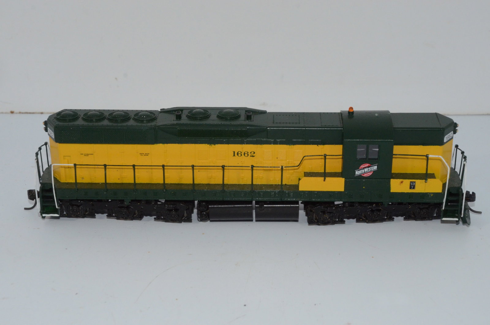 Chicago and Northwestern RR SD7 Diesel Locomotive-HO Scale: This is a Chicago and Northwestern Railroad SD7 diesel locomotive #1662 in HO scale. Has a replacement Ajin precision drive unit and chassis. Nice used item that has been tested and runs well. Shell i