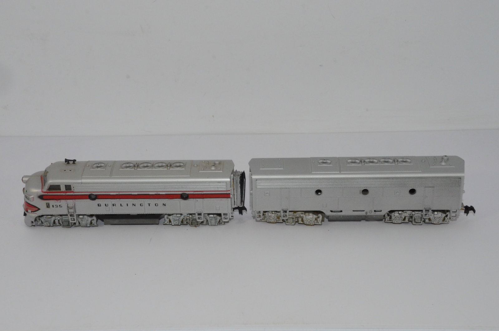 Chicago Burlington and Quincy RR F7A/B Diesel Locomotives-HO Scale: This is a Chicago Burlington and Quincy Railroad F7A/B diesel locomotive set in HO scale. Both have been tested and run. The A unit is numbered 135 and has a Hobbytown of Boston drive unit/chassis. Th