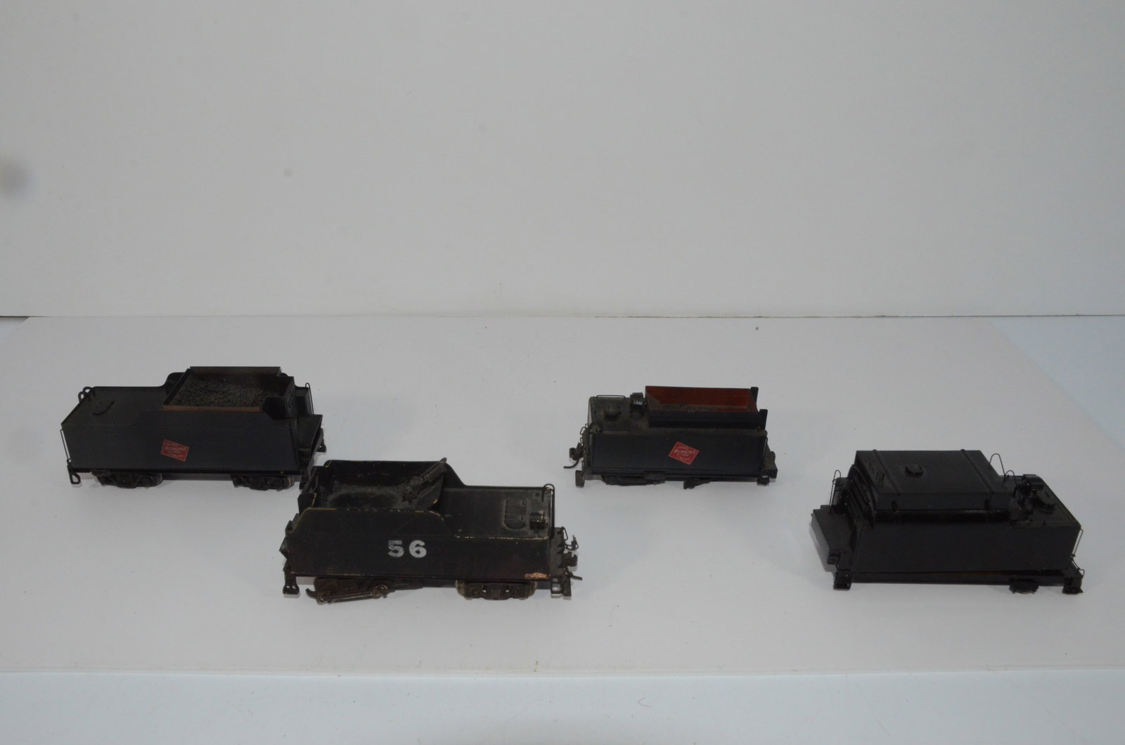 Four Brass Steam Locomotive Tenders-HO Scale: This is a lot of four different brass steam locomotive tenders. Two are lettered for the Milwaukee Road. The smaller of the two needs a set of trucks. The third is numbered 56, and the final one is ha