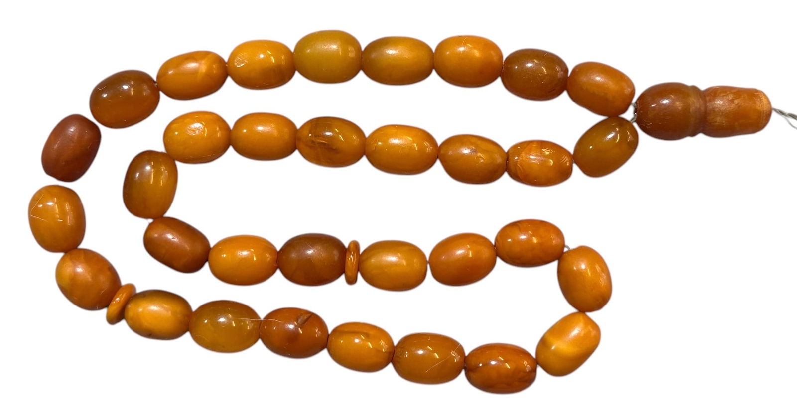 Antique Islamic Ottoman Islamic Natural Amber Beads 29 grams: Antique Islamic Original Ottoman Islamic Natural Amber Beads 29 grams. A total of 33 natural amber stringed beads plus two smaller divider beads, with a natural amber minaret alif bead end. A total of