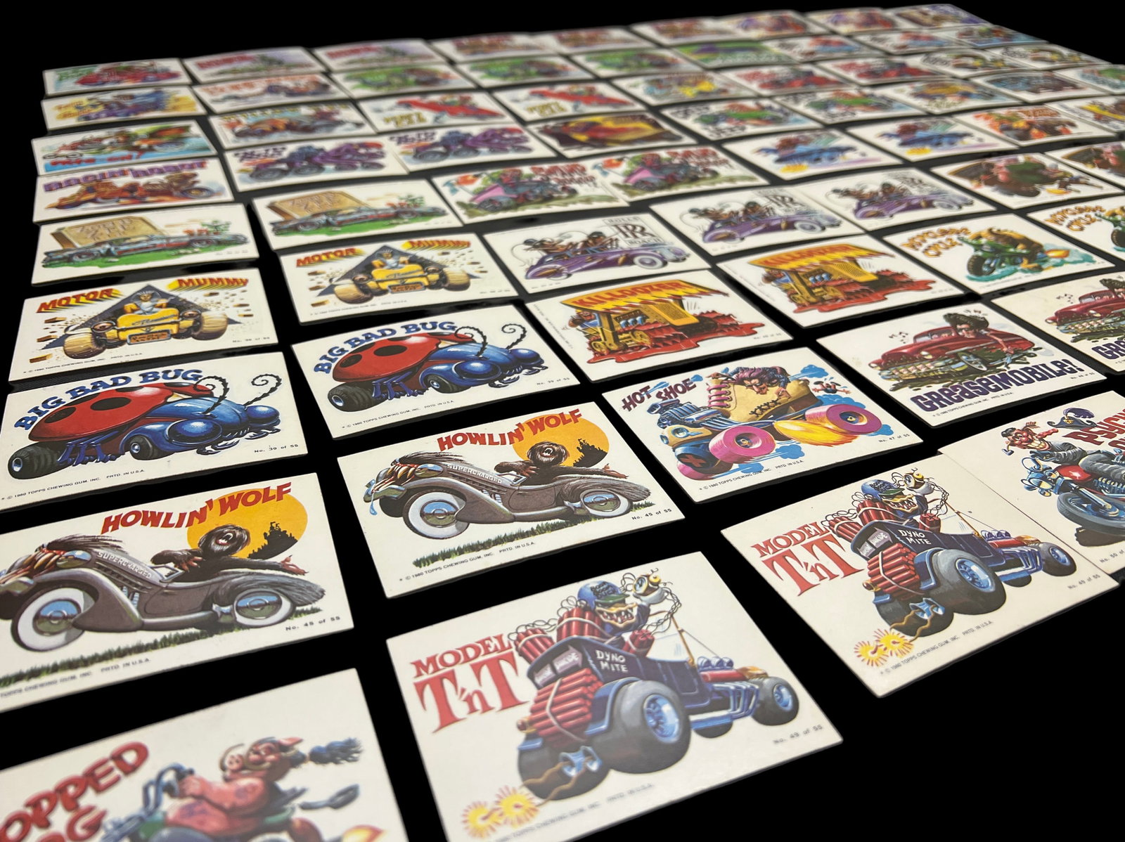 Lot of 83 Topps "Weird Wheels" cards from 1980: This lot of 83 cards features a collection of vintage 1980 Topps Weird Wheels trading cards, showcasing wacky, monstrous, and creatively designed vehicles in a humorous and grotesque style. Each card 