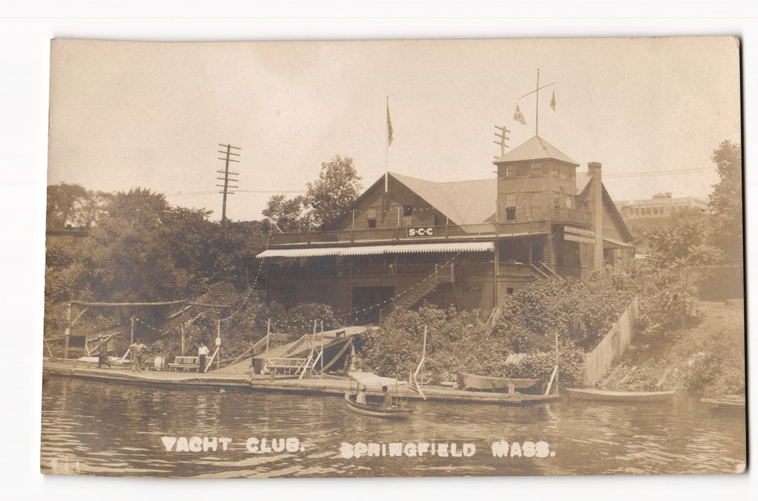 Yacht Club, Springfield, Mass., S-C-C Building on Waterfront, Early 20th Century RPPC: The front of this real photo postcard features a sepia-toned image of a large, multi-story wooden building identified as the "S-C-C" Yacht Club, situated on a sloped bank leading down to a body of wat