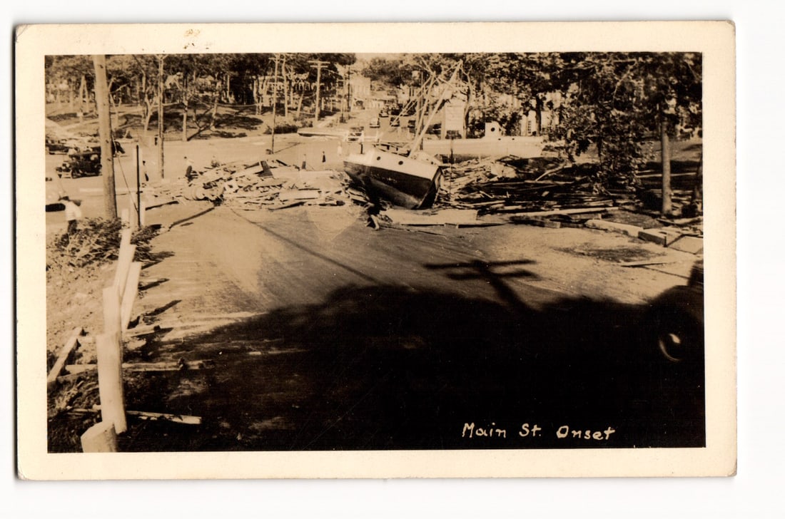 Main Street, Onset: Scene of Destruction with Beached Sailboat, Uprooted Trees, Debris, RPPC (1 of 2)