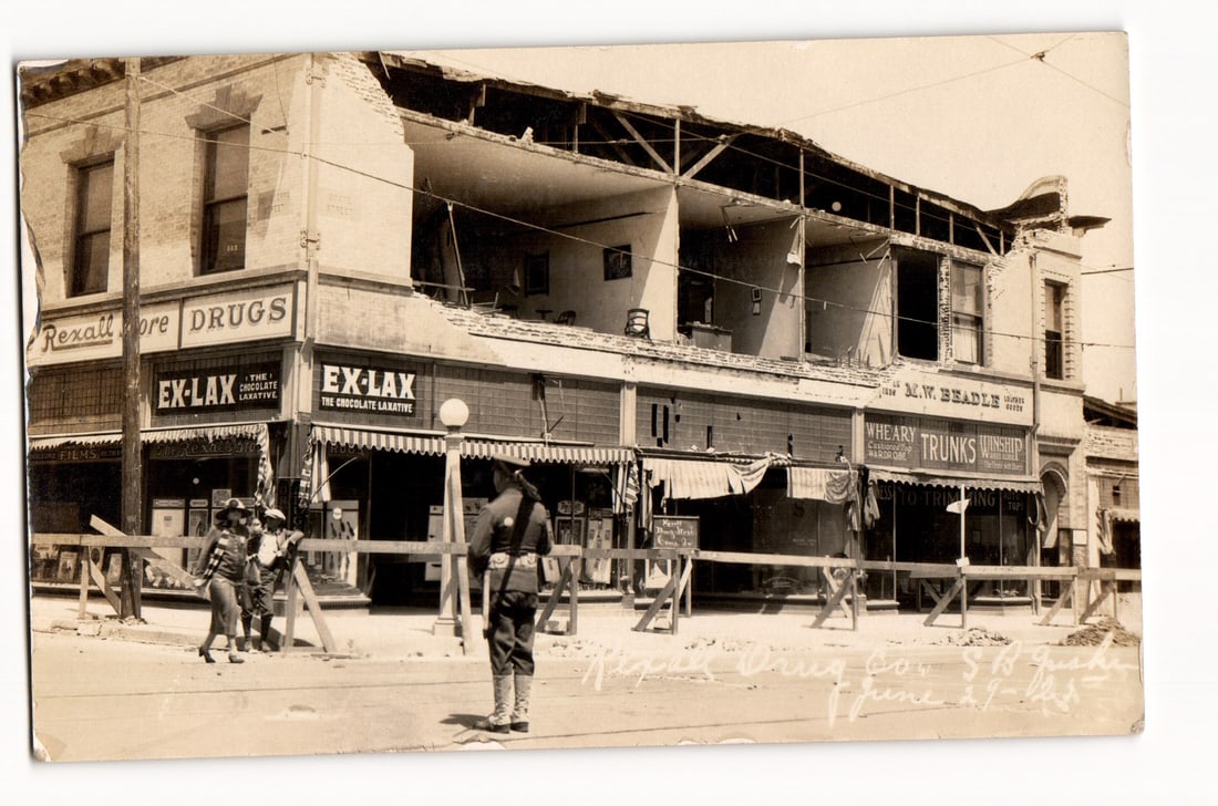 Damaged Commercial Building, Rexall Drugs, Ex-Lax, S.B. Ind., Dodd Street, June 29, 1925 RPPC: This Real Photo Postcard (RPPC) displays a black and white, sepia-toned photograph documenting extensive damage to a two-story brick commercial building. The second floor and roof are partially collap