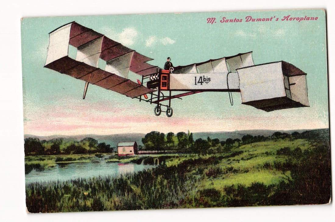 M. Santos Dumont's Aeroplane "14bis" in Flight Over Landscape, Early 20th Century Aviation: The front of the postcard presents a colorized illustration. The primary subject is an early fixed-wing aircraft, identified by "14bis" in black numerals on its side, shown in flight, angled upwards a