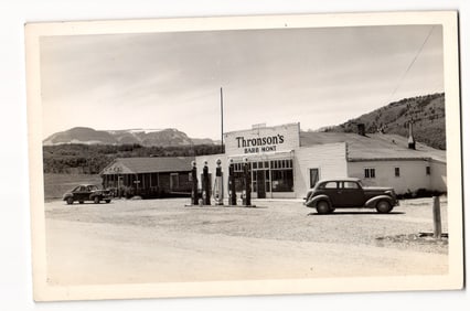 RPPC Thronson's Babb Mont. Store, Gas Pumps, Antique Automobiles, Mountains, Montana, c. 1940s