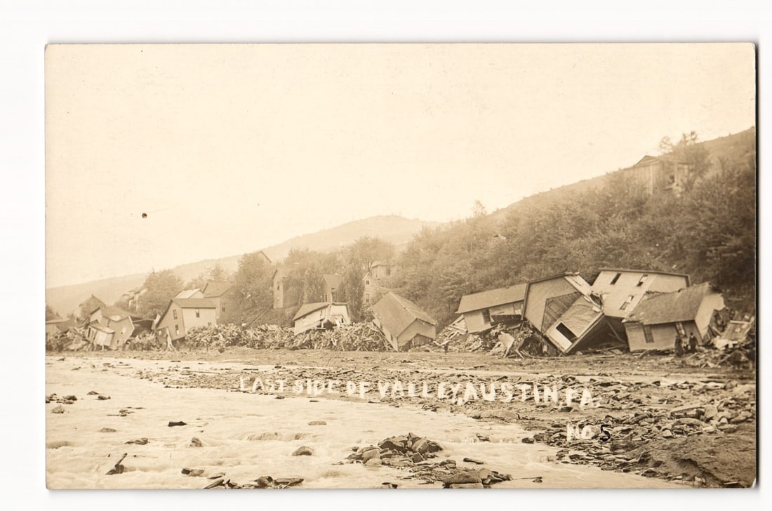 Vallcarca Flood Disaster: Damaged and Displaced Houses Along River, No. 5, Sepia RPPC Photo: The front of the postcard displays a sepia-toned photograph, identified as a Real Photo Postcard (RPPC). The image captures the aftermath of a destructive event, showing numerous wooden structures, co