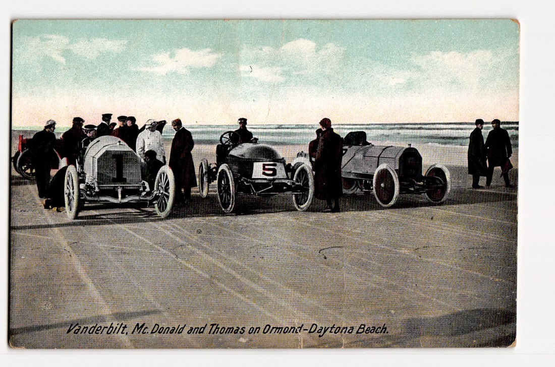 Early 20th C. Race Cars: Vanderbilt, McDonald, Thomas on Ormond-Daytona Beach, Auto Racing: The postcard front features a colorized photograph depicting three early 20th-century racing automobiles on a wide, sandy beach, identified by a caption as Ormond-Daytona Beach. Car number "1" is prom