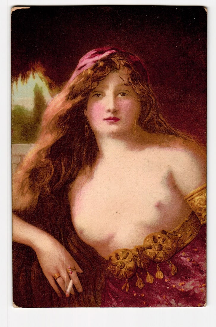 Artistic Portrait of Woman with Long Hair, Cigarette, and Ornate Garb, Early 20th Century: The front of the postcard features a color illustration, likely a chromolithograph, depicting a woman from the chest up. She has long, flowing auburn hair, pale skin with rouged cheeks and red lips, a