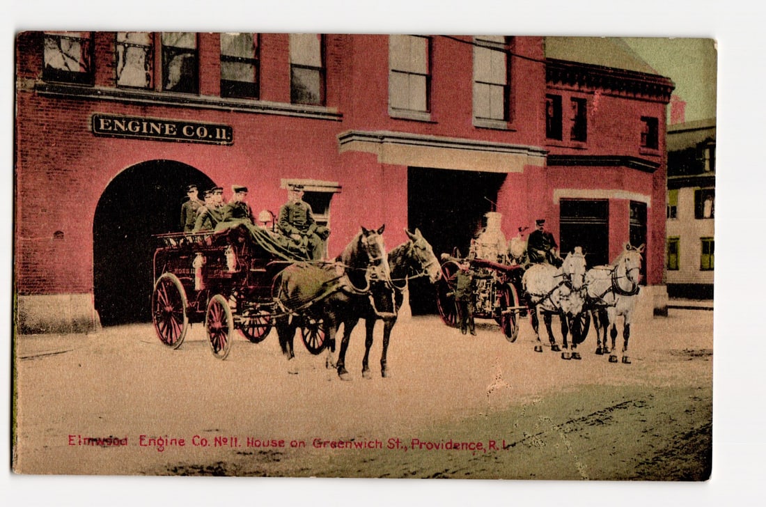 Elmwood Engine Co. No. 11 Firehouse, Horse-Drawn Engines, Greenwich St., Providence, R.I.: The front of this colorized printed photograph postcard depicts the Engine Co. 11 firehouse. The red brick building features "ENGINE CO. 11." printed in white lettering above a large, dark arched cent