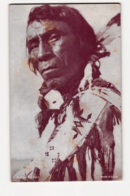 Sepia-Toned Photograph of a Native American Man in Beaded Attire and Feathers, 'Indian Portrait'.