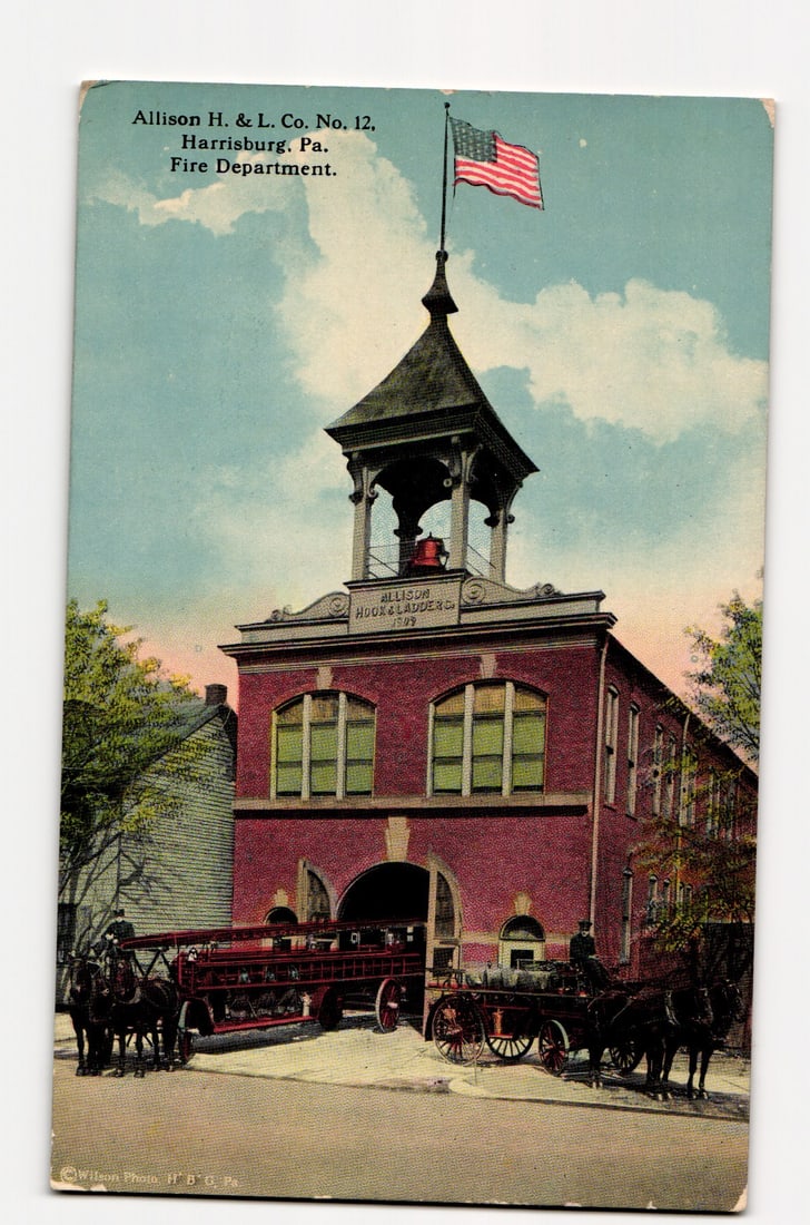 Allison H. & L. Co. No. 12, Fire Department, Harrisburg, PA. Horse-Drawn Apparatus, Early 1900s: A colorized image depicts the Allison H. & L. Co. No. 12 Fire Department building in Harrisburg, PA. The two-story red brick structure features a central bell tower, from which an American flag is fly
