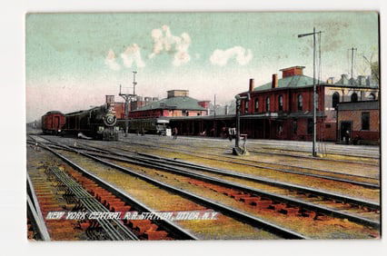 Postcard depicting the New York Central R.R. Station in Utica, N.Y. with steam locomotive.