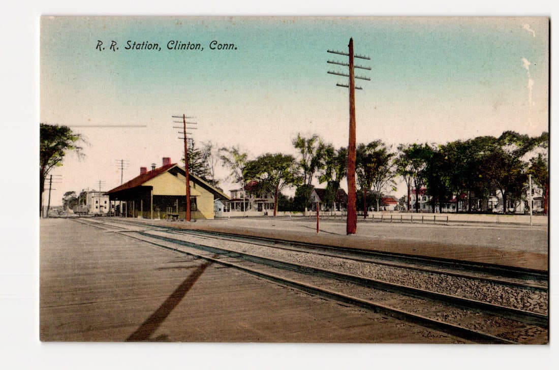 R. R. Station, Clinton, Connecticut. Early 20th Century View with Tracks and Buildings. Postcard.: A colorized image shows the R. R. Station in Clinton, Connecticut. The perspective is eye-level, looking along a set of multiple railway tracks that recede into the distance. To the left of the tracks