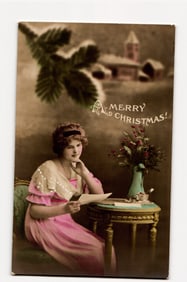 Antique Christmas postcard: Woman writing a letter; Printed "Kraków, Poland" on reverse.