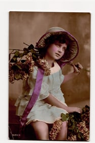 Hand-Tinted Real Photograph Postcard: Young Girl in Blue Dress, Hat, Purple Ribbon, Flowers