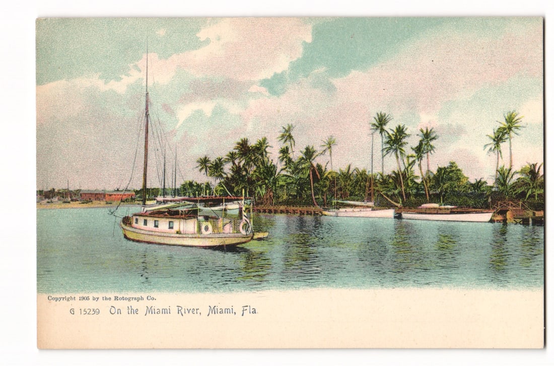 Postcard View of Miami River, Miami, Fla. with Boats and Palm Trees, Rotograph Co. 1905: A colorized depiction shows the Miami River, Miami, Florida. Several boats are on the water; a prominent light-hulled cabin cruiser with a single mast and visible cabin windows is in the left foregrou