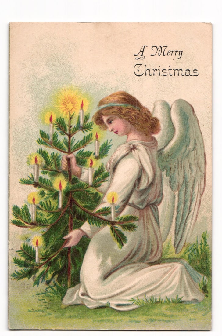 Chromolithograph Postcard of an Angel with a Lit Christmas Tree, "A Merry Christmas", 1905: The front of this chromolithograph postcard depicts an angel in a white, draped garment, kneeling on green grass. The angel has light brown, wavy hair adorned with a light blue band and possesses ligh