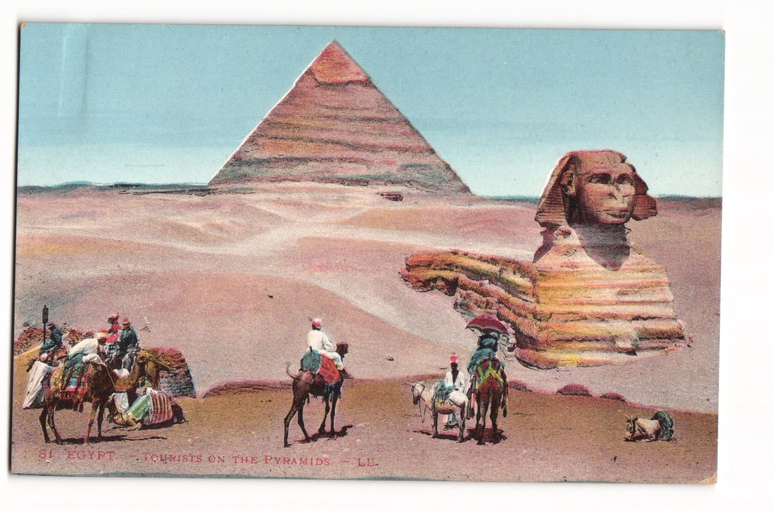 Egypt Postcard: Tourists on Camels and Donkeys at the Great Pyramid and Sphinx, Giza Plateau - LL: A colorized image shows the Great Pyramid in the background, under a clear sky, with the Great Sphinx to its right, viewed from its right side. The foreground depicts a sandy desert landscape. Several