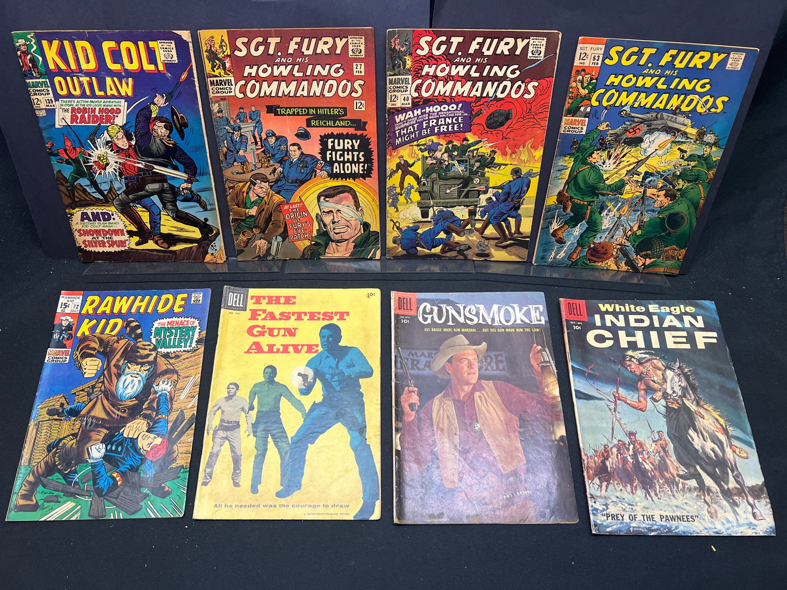 Lot of Assorted Western & War Comic Books, feat. Sgt. Fury, Kid Colt, Gunsmoke, Rawhide Kid: This lot presents a selection of vintage comic books, primarily from the Western and War genres. Prominent Marvel titles include several issues of *Sgt. Fury and his Howling Commandos*, such as #27 wh