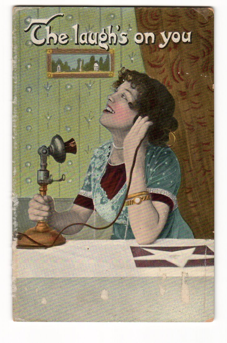 Illustrated Postcard: Woman at Candlestick Telephone, "The laugh's on you", Germany Series 175.: A color illustration depicts a woman with dark, styled hair, wearing a pearl necklace, a gold bracelet, and a teal and maroon dress with white lace trim. She is seated, looking upwards and to her left
