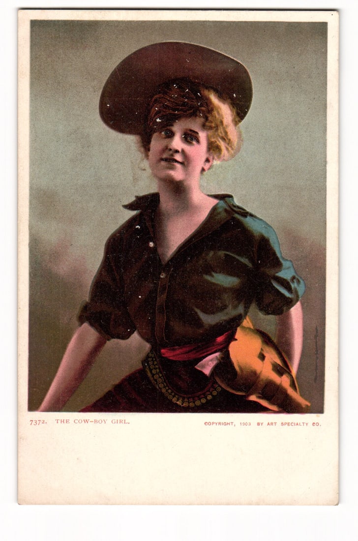 Antique Postcard: The Cow-Boy Girl, Copyright 1903 by Art Specialty Co., Undivided Back: A color printed postcard featuring a portrait of a woman dressed as "THE COW-BOY GIRL." She is depicted from the waist up, angled slightly to the viewer's right, her head tilted back, looking upwards
