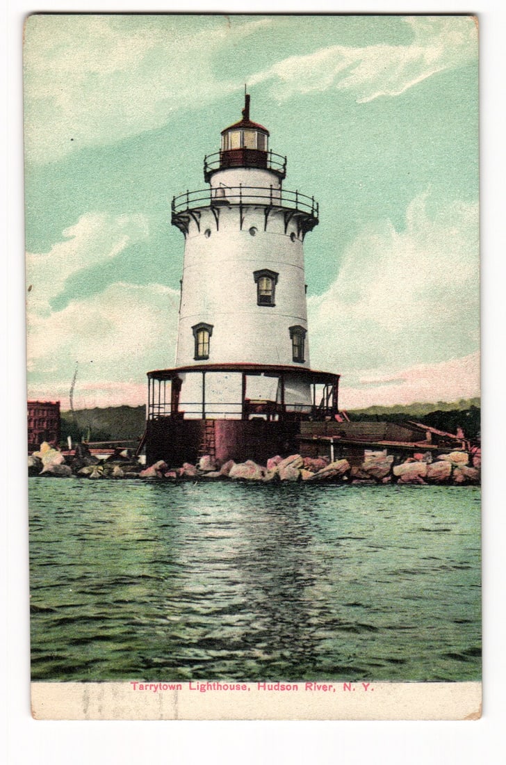 Tarrytown Lighthouse on the Hudson River, N.Y. 1901 Postmarked Litho-Chrome Postcard: A colorized image shows the Tarrytown Lighthouse, a white, cylindrical structure with multiple windows and a black lantern room, situated on a rock foundation. It features a prominent wraparound porch