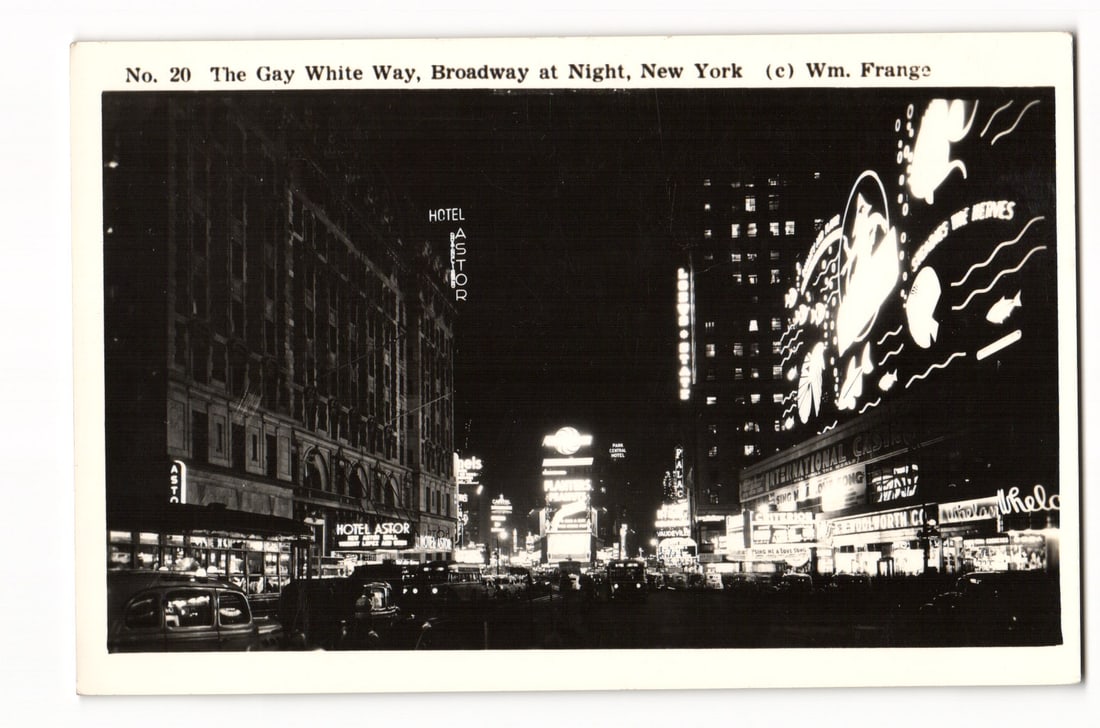 No. 20 The Gay White Way, Broadway at Night, New York, Hotel Astor, Wm. Frange postcard: A black and white photographic postcard depicting a night scene on Broadway, New York, also known as "The Gay White Way." The view looks down the street, flanked by multi-story buildings. Prominently