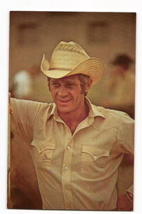 Steve McQueen in Cowboy Hat, Color Photo Postcard, CL/Personality #83, 1981 Sygma, California: A color photograph depicts a man, identified on the reverse as Steve McQueen, wearing a light-colored straw cowboy hat with ventilation holes and a patterned band. He is dressed in a light-tan, vertic