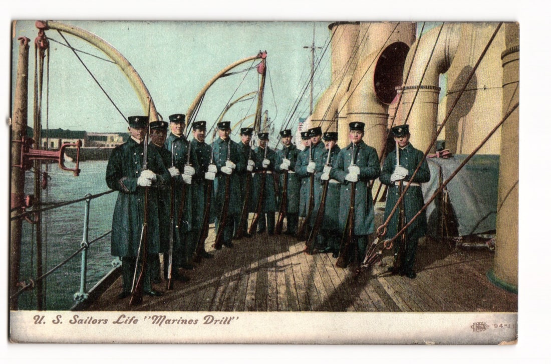 U.S. Sailors Life "Marines Drill" On Ship Deck, Military Uniforms, Early 20th Century Postcard: A colorized image shows twelve U.S. military personnel, per the caption "Marines Drill", in formation on a ship's wooden deck. They wear dark long coats, trousers, and garrison caps, each holding a ri