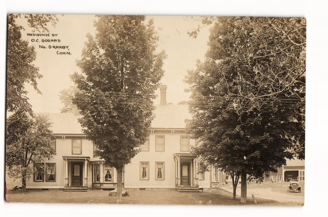 Residence of O.C. Godard, No. Granby, Connecticut, Sepia Tone Real Photo Postcard (RPPC): A sepia-toned photograph shows a two-story, light-colored clapboard building. Printed in the upper left corner is the text: "RESIDENCE OF O.C. GODARD No. GRANBY, CONN." The structure features multiple