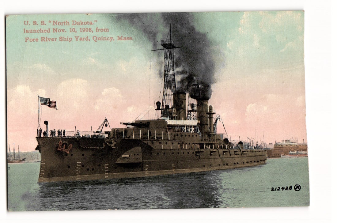 U.S.S. North Dakota, Launched 1908, Fore River Ship Yard, Quincy, Mass. Colorized Postcard: A colorized image depicts the U.S.S. North Dakota, a naval warship, shown from a port side perspective, steaming towards the left of the frame. The vessel features multiple gun turrets, two prominent