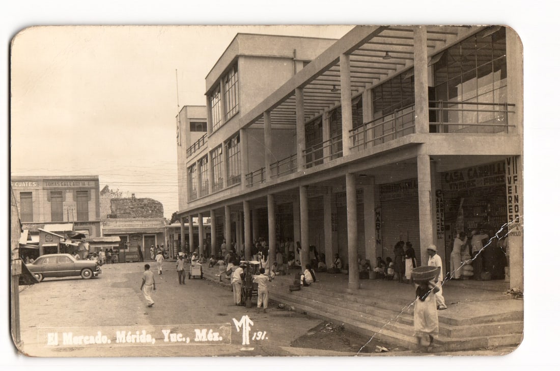 El Mercado, Mérida, Yucatán, Mexico. Street Scene with Figures and Shops. RPPC Postcard No. 191.: A sepia-toned photographic image depicts a street scene in front of "El Mercado" (The Market) in Mérida, Yucatán, Mexico. The perspective is eye-level, showcasing a multi-story building with a promi