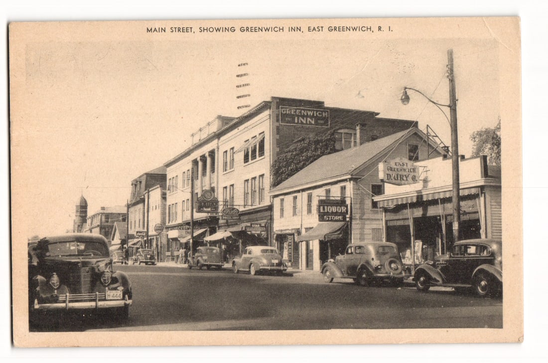 Main Street with Greenwich Inn & Vintage Cars, East Greenwich, R.I. 1946 Postmark Postcard: A sepia-toned photographic view captures Main Street in East Greenwich, R.I., looking down the street from an angled perspective. Several automobiles, appearing to be from the 1930s and early 1940s, a