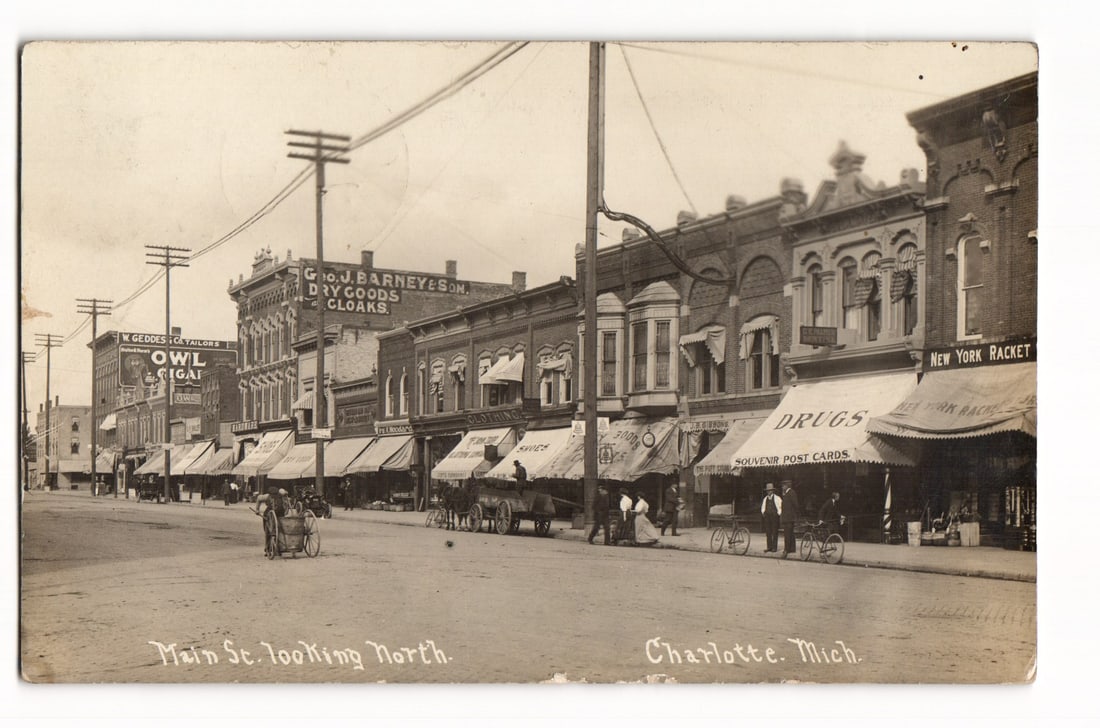 Main St. looking North, Charlotte, Mich. bustling street scene, early 20th century postcard (1 of 2)