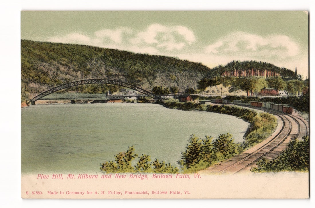Pine Hill, Mt. Kilburn and New Bridge, Bellows Falls, Vt. Scenic Landscape Postcard, Germany: This postcard features a colored illustration of a landscape. In the foreground is a body of water, with a long, arched bridge traversing it from left to mid-right. A railway line with a train consist