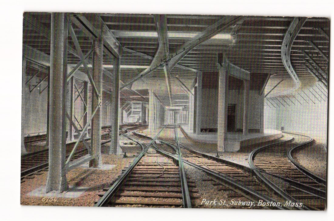 Park St. Subway Interior, Tracks & Platforms, Boston, Mass. Undivided Back Postcard No. 6754: A colorized image depicts the interior of the Park St. Subway in Boston, Massachusetts, featuring a complex arrangement of railway tracks converging and diverging. Numerous structural support columns