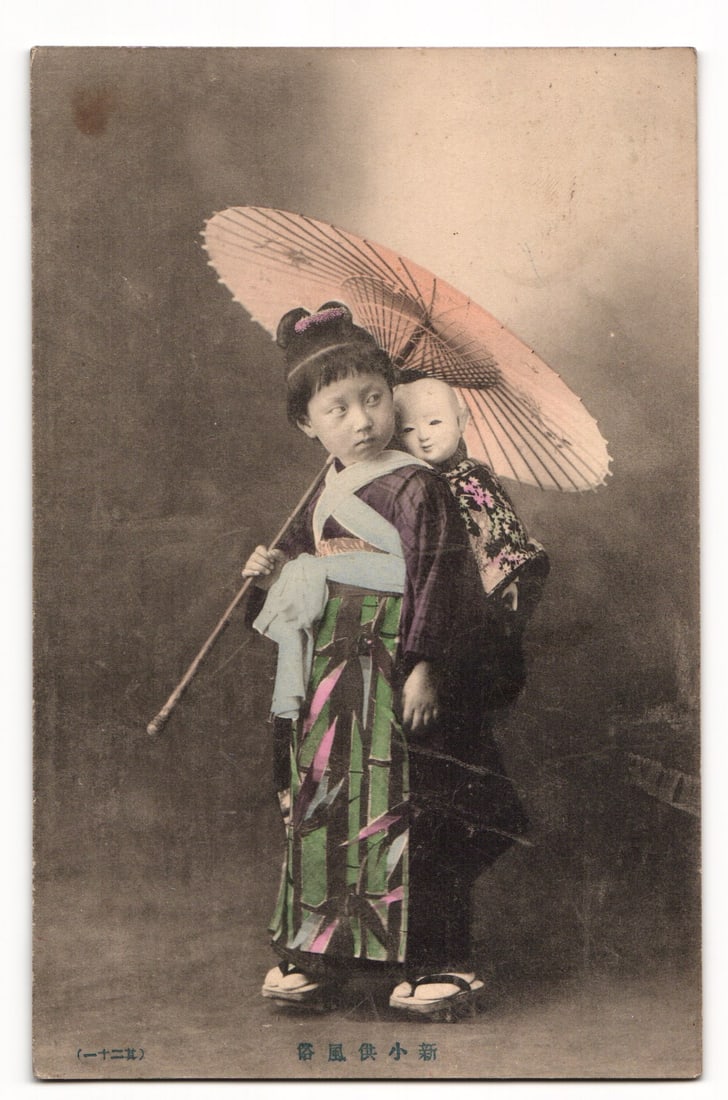 Postcard of a Young Japanese Girl in Kimono with Doll on Her Back and Parasol, Studio Portrait (1 of 2)