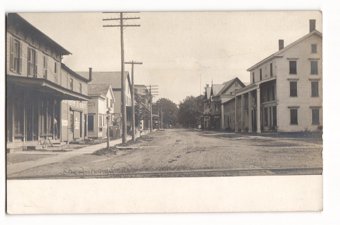 RPPC Sherburne, N.Y. Main St. with Dirt Road, Shops, Homes, Poles, Early 1900s Cyko Postcard (1 of 2)