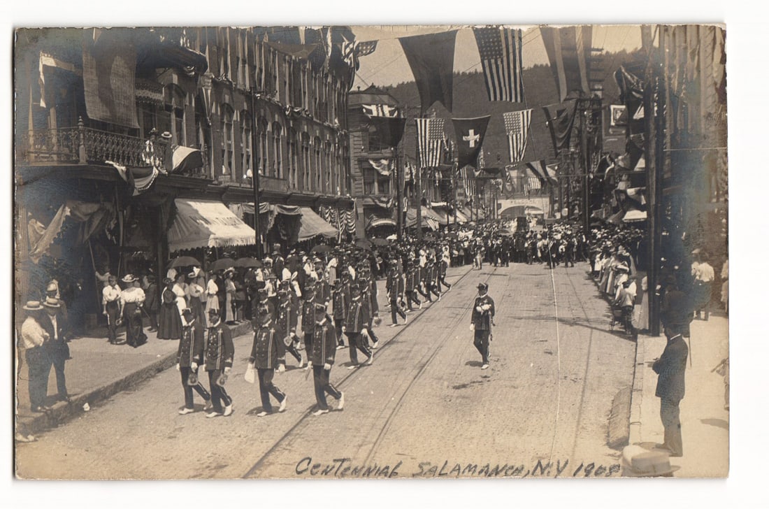RPPC Postcard: Salamanca, NY Centennial Parade, 1908. Street scene, uniformed marchers, spectators, (1 of 2)