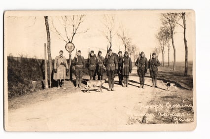 WWI RPPC of American Doughboys with Rifles and Mascot Dogs on a Rural Road in France, c. 1918